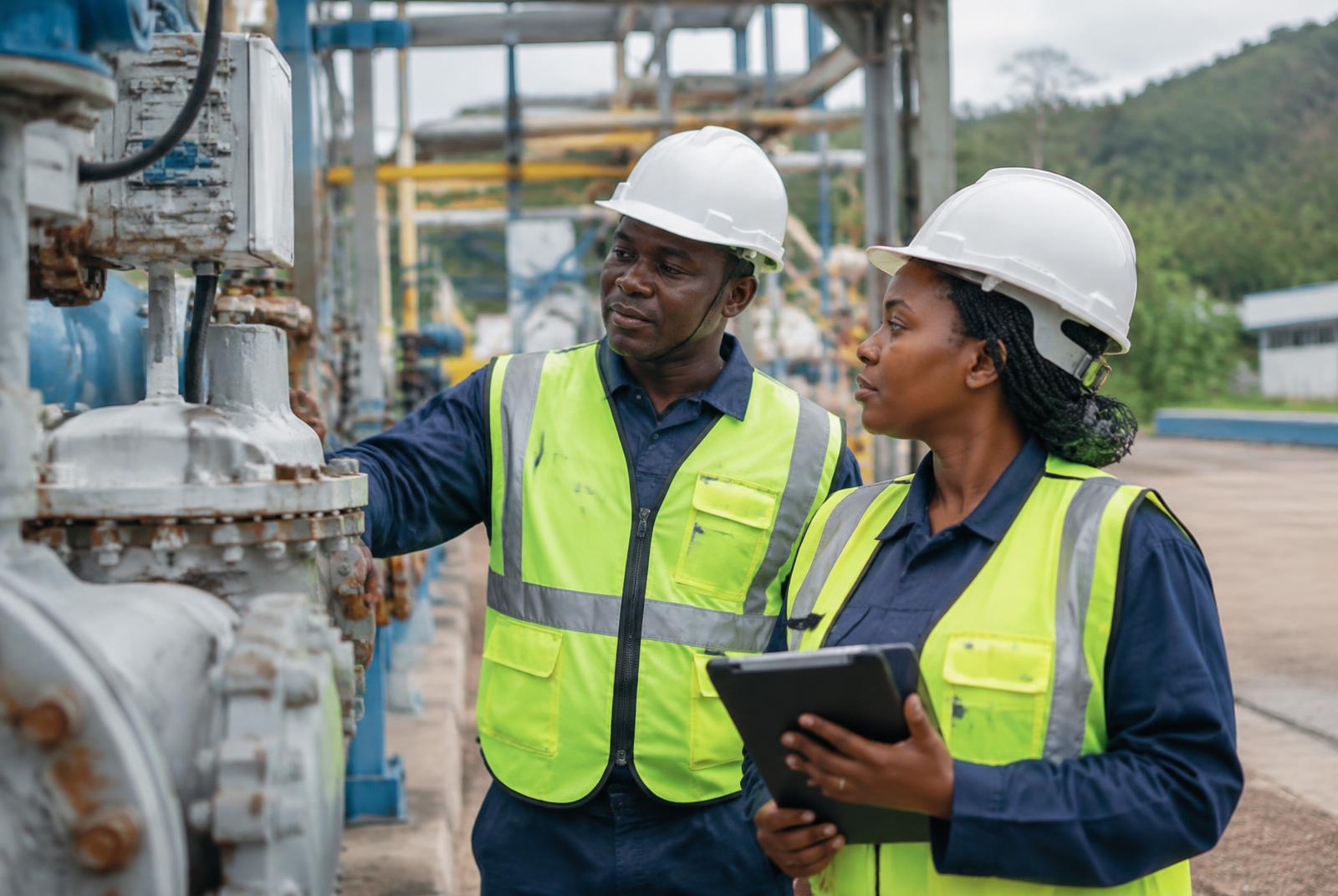 Industrial team inspecting equipment on site